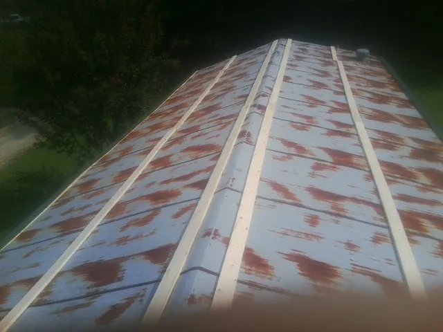 Rusted metal roof panels with new wood purlins before replacement — Storm Damage Roof Repair in Saint Helena by Roofing Brothers